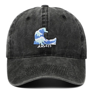 Detail of grey washed cotton baseball cap with embroidered wave pattern and Japanese text
