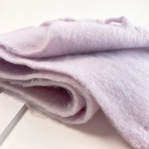 Close-up of light purple mohair scarf fabric showing soft fuzzy texture and wool fibers