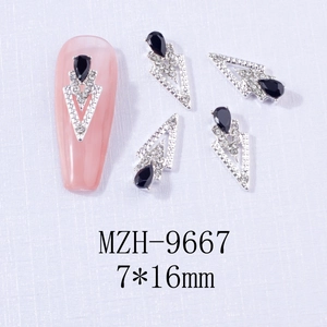Macro shot of 7x16mm alloy nail art charms with black teardrop stones and silver frames