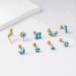 Set of 9 gold bohemian cartilage studs with turquoise stones in snake and star designs
