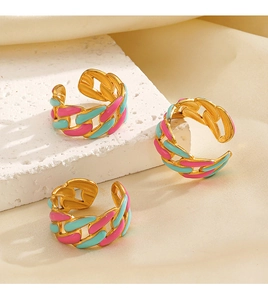 Detail of gold chain rings with pink and blue enamel finish on stone display