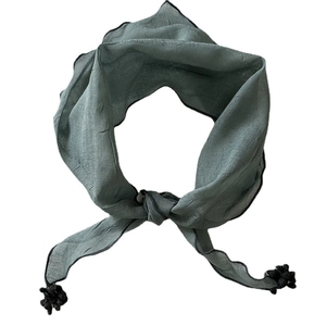 Elegant sage green triangle scarf with black tassels and fringe on a white background