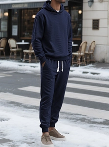 Detail of navy knit hoodie set with jacquard texture on outdoor model in snowy street