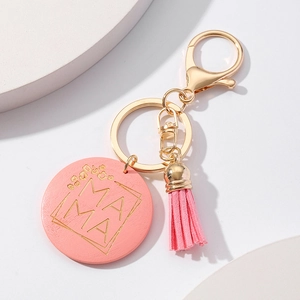 Close-up of pink wooden Mama tag with gold lettering, fringe tassel and metal lobster clasp