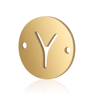 Macro shot of gold stainless steel circular pendant with cutout letter Y and dual holes