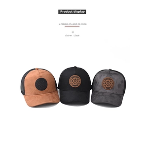 Detailed view of three mesh trucker hats in brown, black and grey with round patches