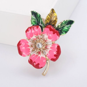 Elegant peach blossom enamel brooch with pink petals and crystal center on gold stem
