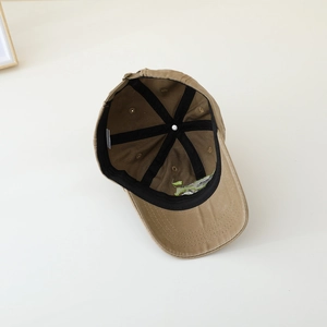 Inside view of khaki kids baseball cap showing reinforced black stitching and breathable fabric