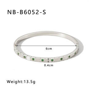 Detail view of silver stainless steel grid bracelet with green zircon stones, 6cm diameter