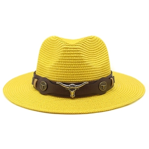 Detailed straw jazz hat with brown leather band and metallic bull head ornament
