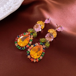 Macro shot of colorful leaf and waterdrop crystals on elegant brown satin fabric