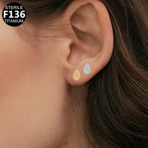 Detail of tear-drop F136 titanium earrings with cubic zirconia in gold and silver