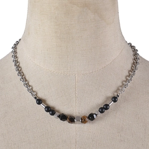 Tiger eye and matte black stone beaded stainless steel necklace on a jewelry bust