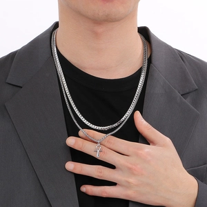 Detail view of double-layer stainless steel necklace with silver Ankh cross pendant