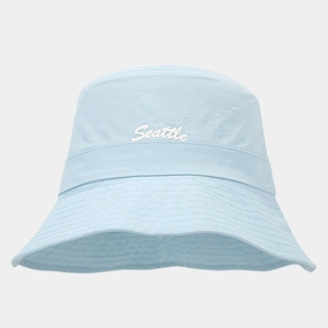 Detail of light blue bucket hat featuring white Seattle embroidery and breathable fabric
