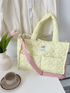 Quilted light yellow tote bag with cloud pattern and adjustable pink shoulder strap