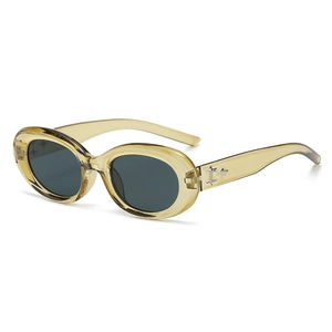 Detail shot of oval transparent amber sunglasses with star metallic studs on temples