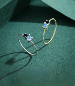 Detail of 925 sterling silver rings with textured band and blue gemstones