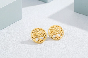 Detailed view of golden stainless steel hollow tree of life earrings with premium finish