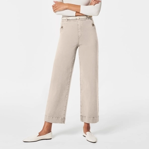 Detail of high-waisted wide-leg khaki pants featuring a slim belt and buttoned side pockets