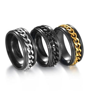 Set of three rotating chain rings in silver, black, and gold finishes on white background