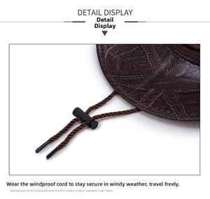 Detail of embossed leaf texture on brown western hat with adjustable chin strap