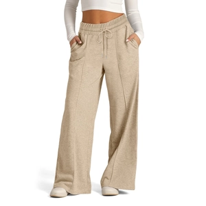 Detailed shot of drawstring high waist and side pockets on beige wide-leg trousers