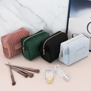 Detailed view of four color corduroy cosmetic bags with zipper closure and hand straps
