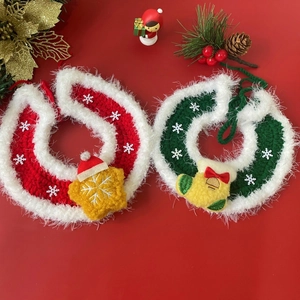 Close-up of knit pet Christmas collars with festive snowflake sequins and charms