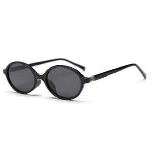 Retro oval black polarized sunglasses with golden metal hinge details on a white background