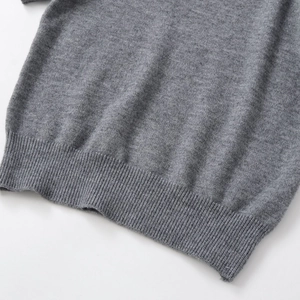 Minimalist grey knit short sleeve top with ribbed hem and high quality fiber texture
