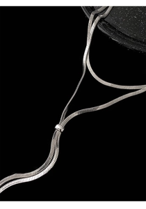 Detailed close-up of a silver snake chain necklace with high-shine metallic texture
