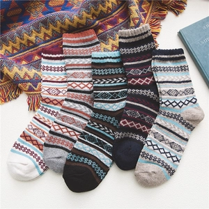 Detailed view of five pairs of thick Fair Isle vintage wool socks in various patterns