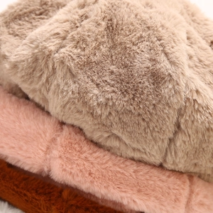 Macro detail of soft fluffy plush texture on minimalist winter bucket hats in various colors