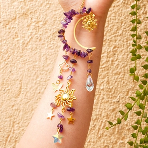 Detail of golden moon suncatcher with purple crystal stones and star charms