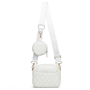 White quilted crossbody bag with adjustable wide strap and small round coin purse accessory