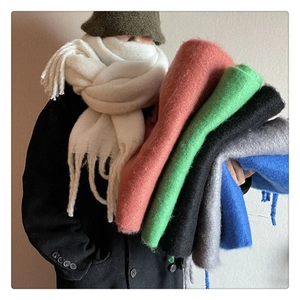 Detail of soft thick mohair winter scarf with long fringe showing fluffy warm texture