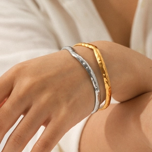 Two-tone gold and silver stainless steel open bangle with hammered texture for women