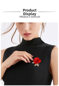 Elegant red rose brooch with gold leaves and rhinestones on black knitwear