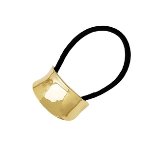 Macro shot of gold metal hair cuff with high-elastic black hair tie on white background