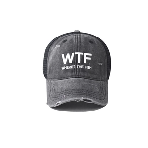 Detail of distressed cotton texture and mesh on a gray WTF embroidered trucker hat