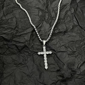 Hip hop silver cross necklace with pavé zircons on black background with twist rope chain