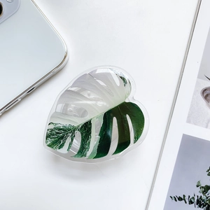 Detail of Monstera leaf phone grip showing white and green acrylic pattern and texture