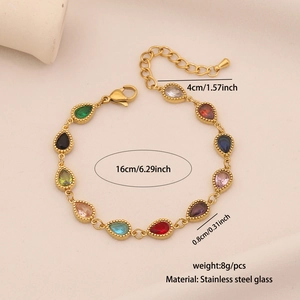 Macro shot of colorful teardrop gemstone charms on a polished gold stainless steel bracelet