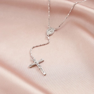 Silver vintage S925 cross necklace with zircon pendant on elegant pink silk fabric
