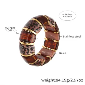 Macro shot of 2.7cm wide resin leopard print bracelet showing elastic structure and gold spacers