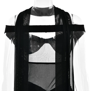 Detail of black semi-transparent mesh fabric with intricate strap design and fine texture