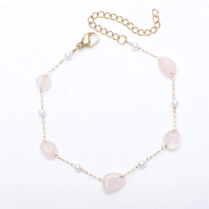 Detail view of pink irregular natural stone bracelet with small pearls and 18K gold chain