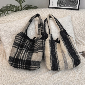 Detail of plush lamb-like wool tote bag with classic black and white plaid patterns