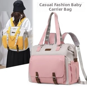 Detail of multi-pocket patchwork diaper bag with top handles and adjustable straps